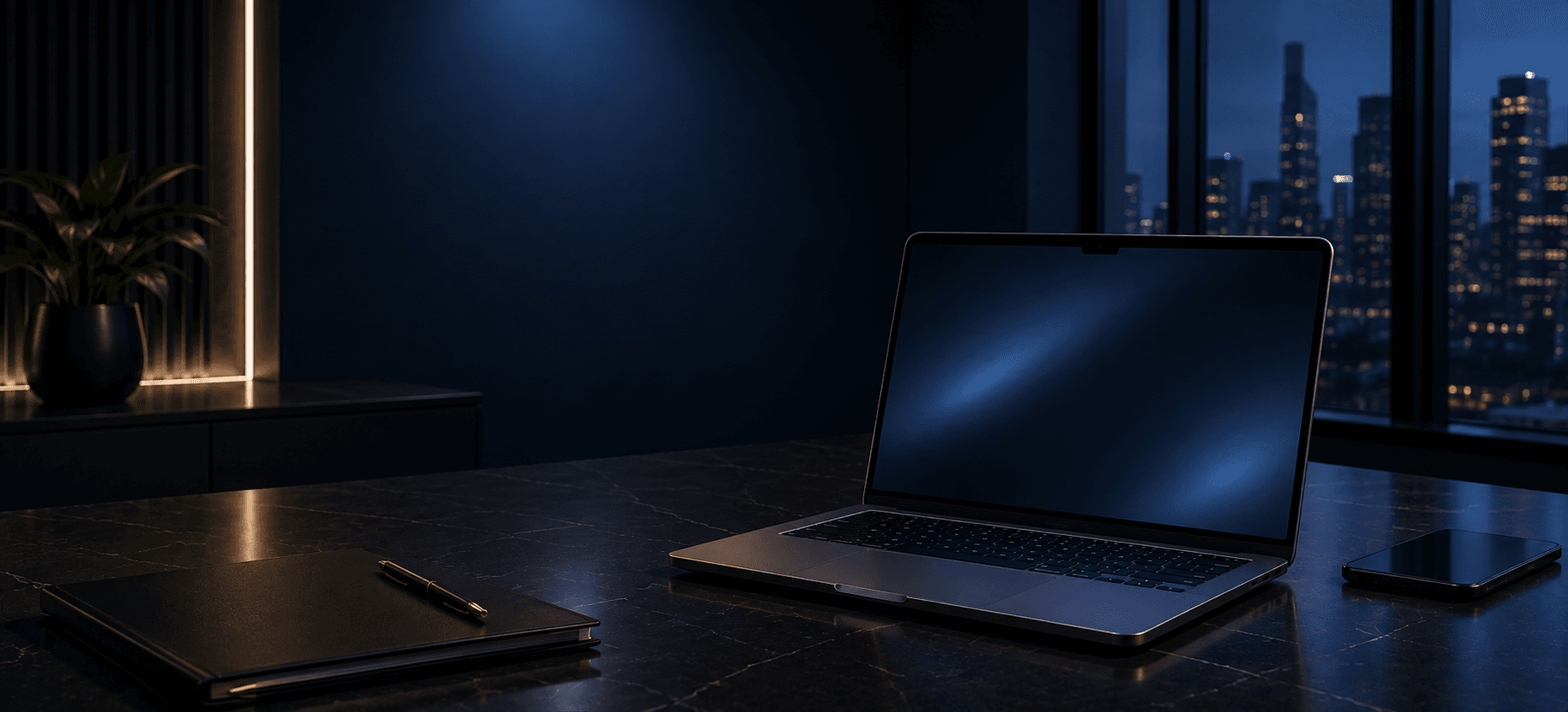 Laptop on a dark marble desk in a modern office overlooking a city at night.
